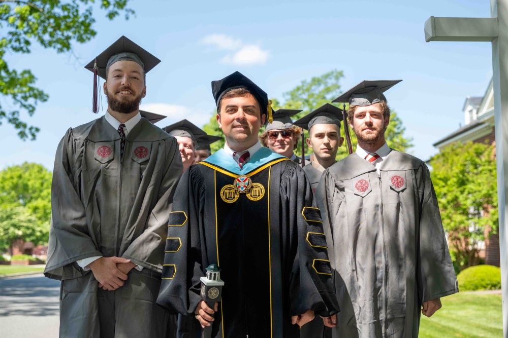 Dean of Students and students in regalia line up for convocation