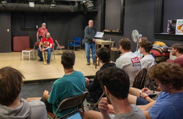 students watching a rehearsal of a play