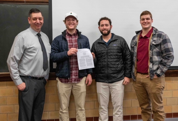 Professor Matyus and 3 students standing together for a photo
