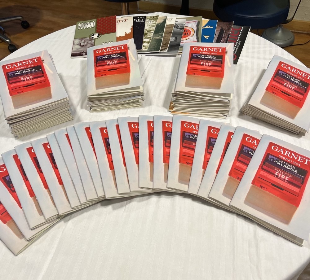 The student-published Garnet magazines spread out on a table