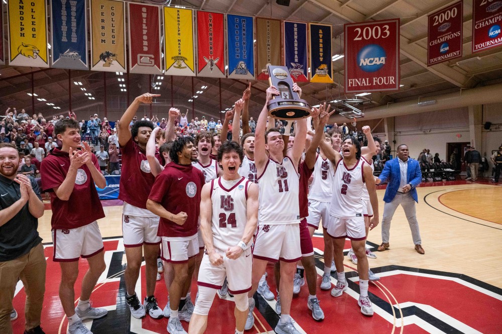 Tiger basketball players holding the ODAC trophy