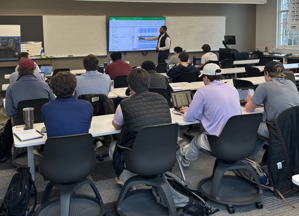 Students sitting in a lecture classroom listening to an instructor