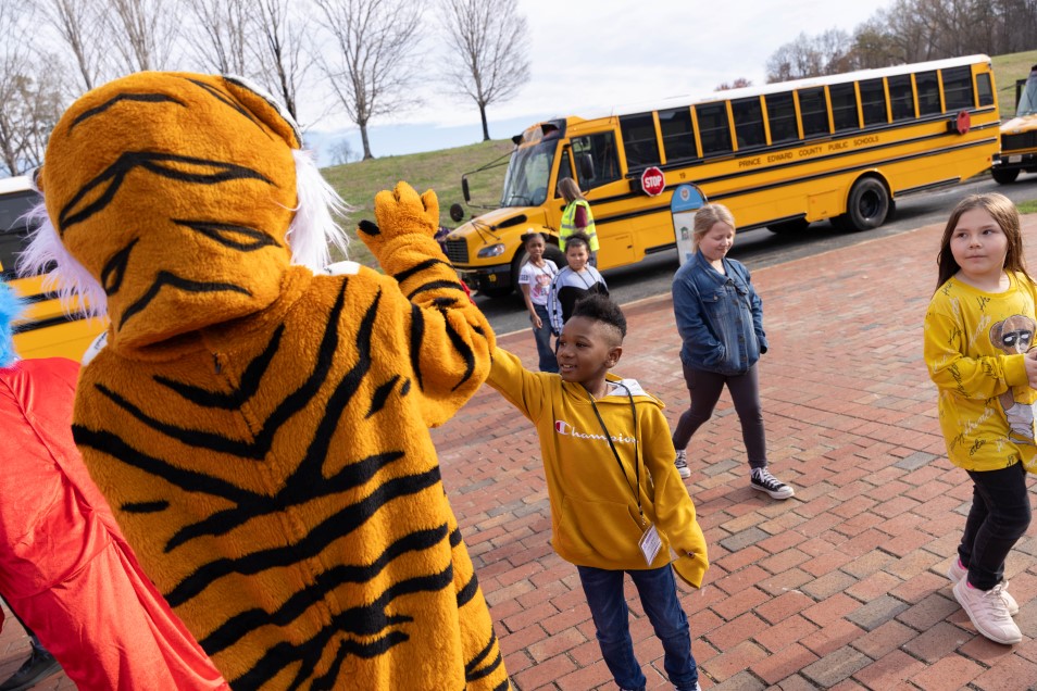 the H-SC Tiger high-fiving a child