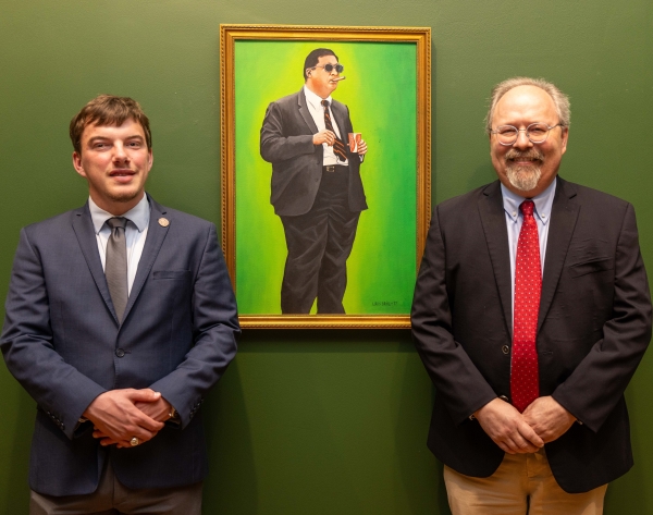 Dr. Utzinger and Jonathan Coleman ’26 standing next to Brinkley's portrait