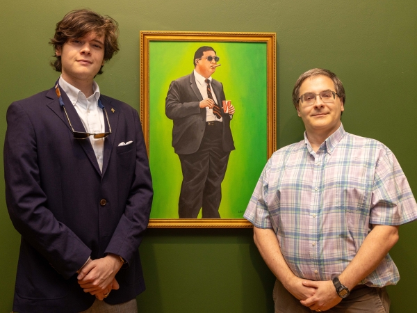 Dr. Hight and Jeb Tucker ’26 standing next to Brinkley's portrait