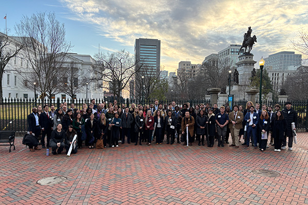 a large group standing in front of the VA state capitol