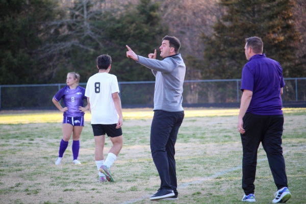 Hampden-Sydney student giving coaching instructions to high school soccer team