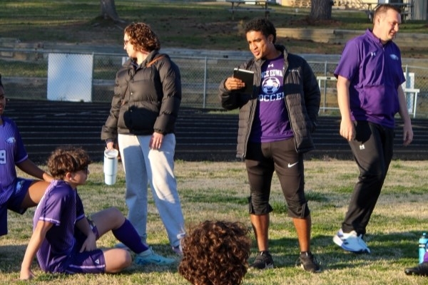 Hampden-Sydney student giving coaching instructions to high school soccer team