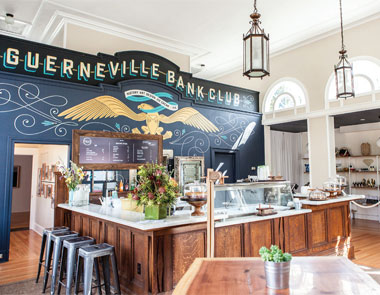 restored Bank Club interior with bar and stools