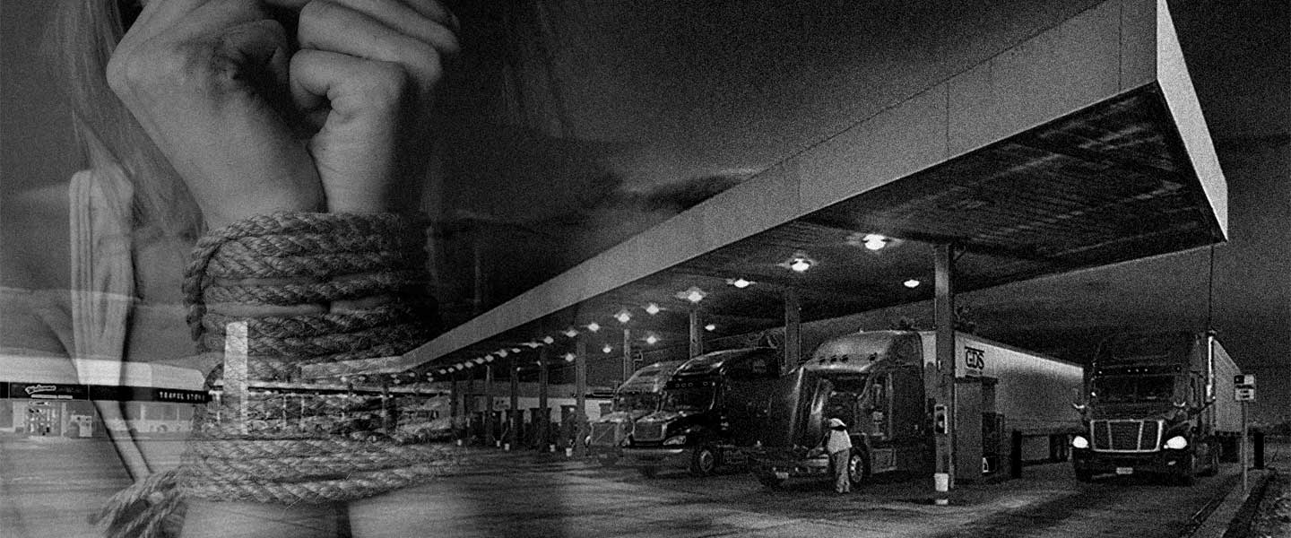 Black and white grainy image of a truck stop