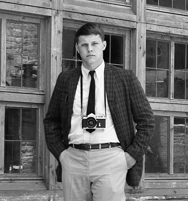 old photo of young Ranny Chitwood with a camera around his neck