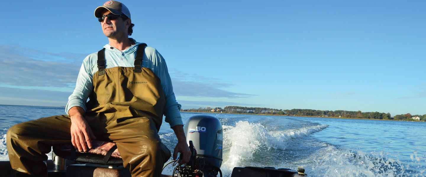 Chris Buck '97, oysterman, on a boat in the Chesapeake Bay banner