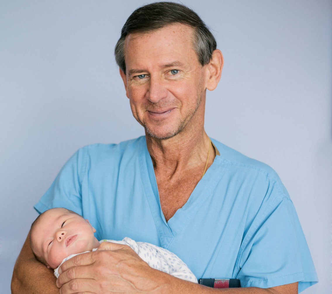 Edward Wolanski holding a newborn infant