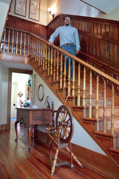 Gordon Johnson '97 standing on a restored stairwell