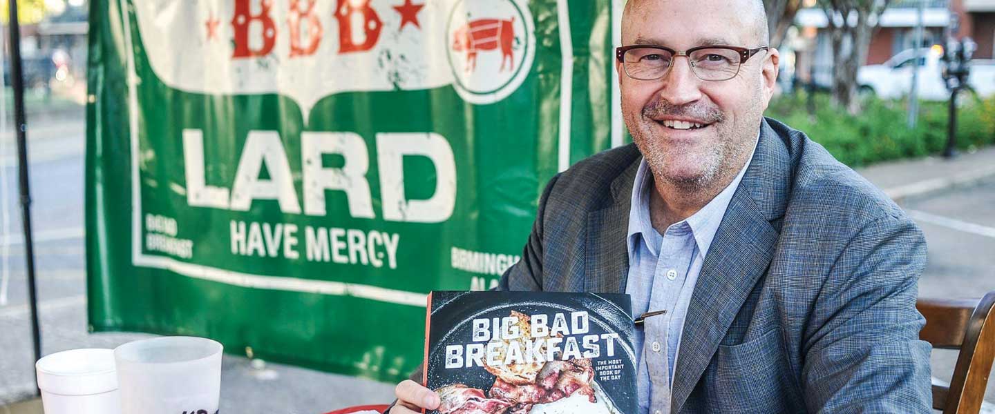 John Currance with his book, Big Bad Breakfast