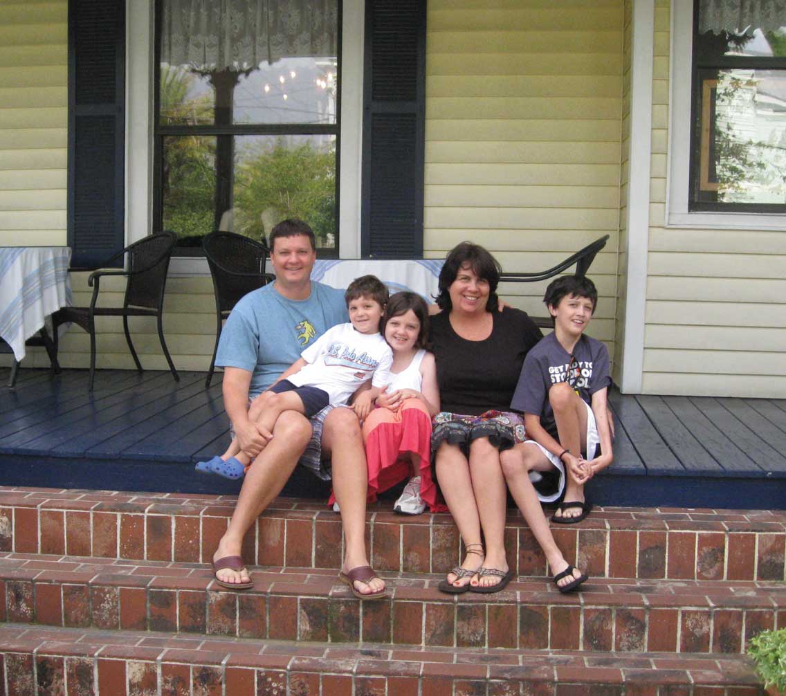 Rick and Michelle Staab on the front porch with their family