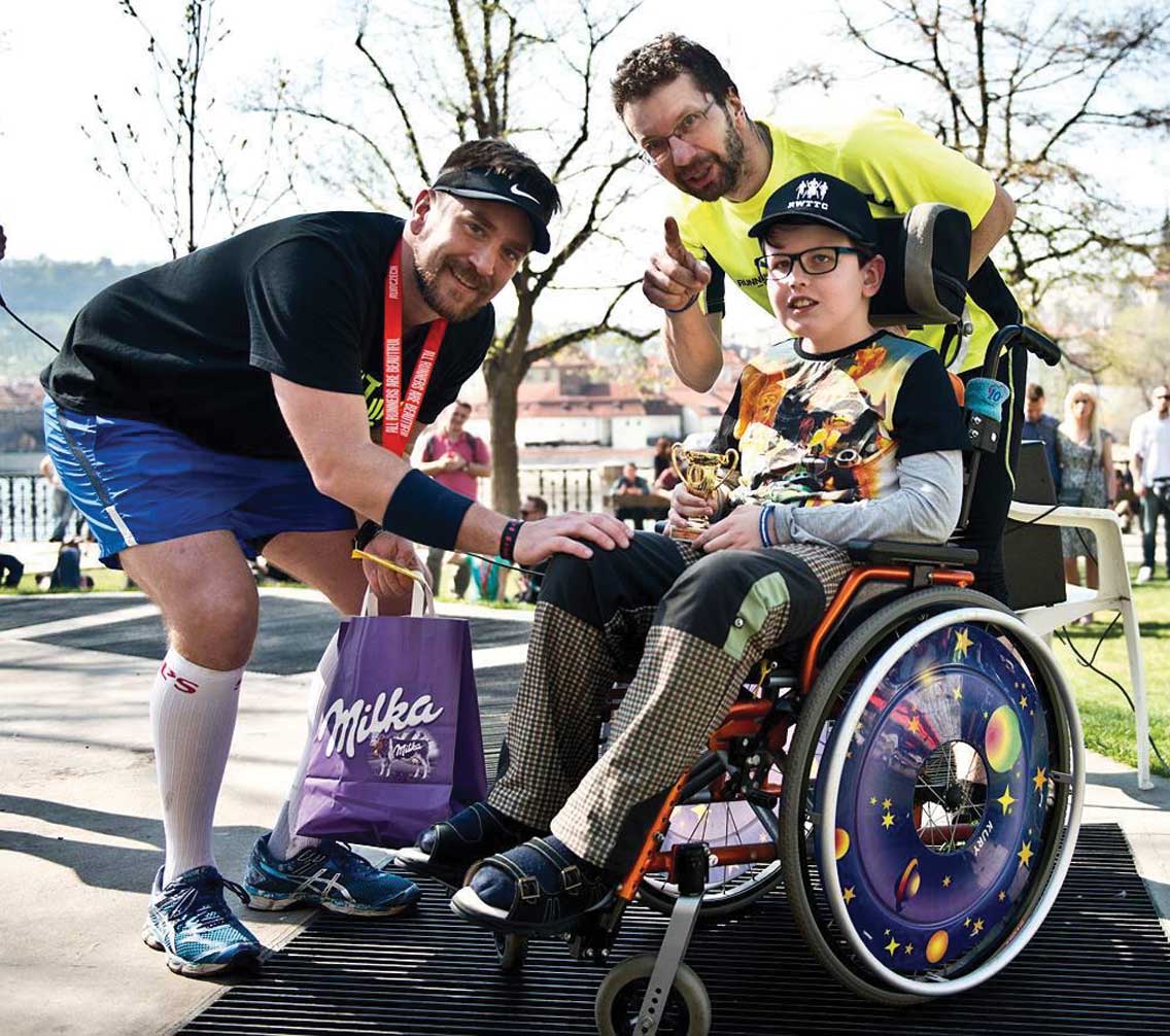 Scott Keel '02 poses with special needs child post-race