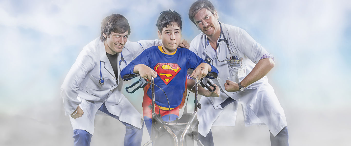 Scott Keel '02 poses with a child in a Superman costume