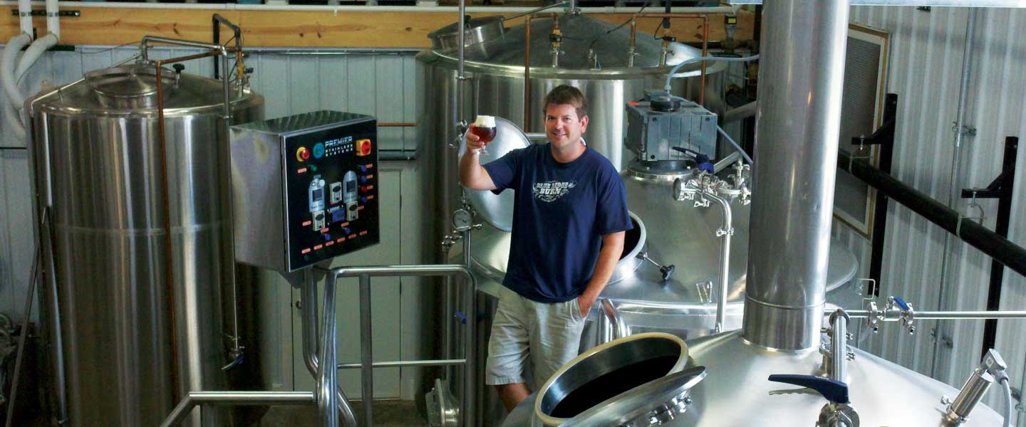 Taylor Smack standing in the brewing room