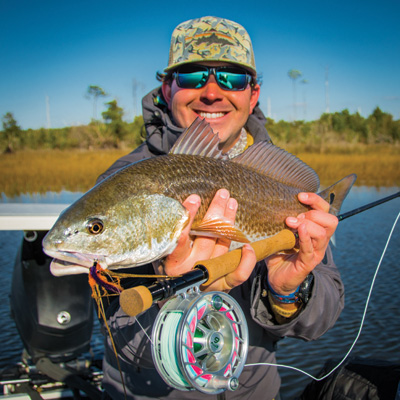 Tom Spencer '10 holding a fish