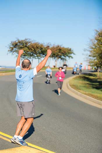 Edward Wolanski cheering on runners in a race