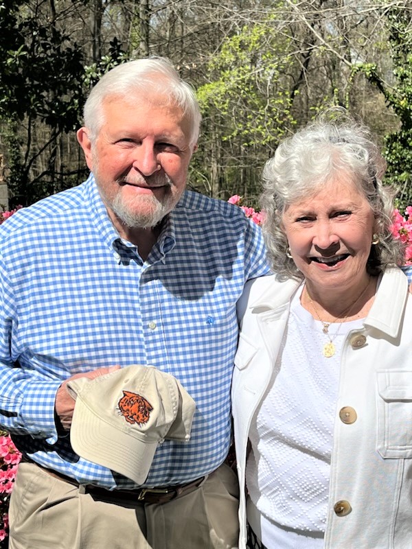 Ken Pritchett and his wife posing outdoors