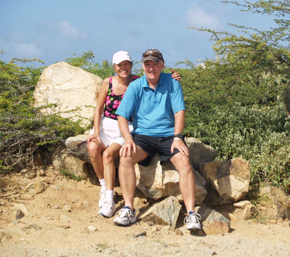 Scott and Susan Harwood sitting at a scenic overlook 