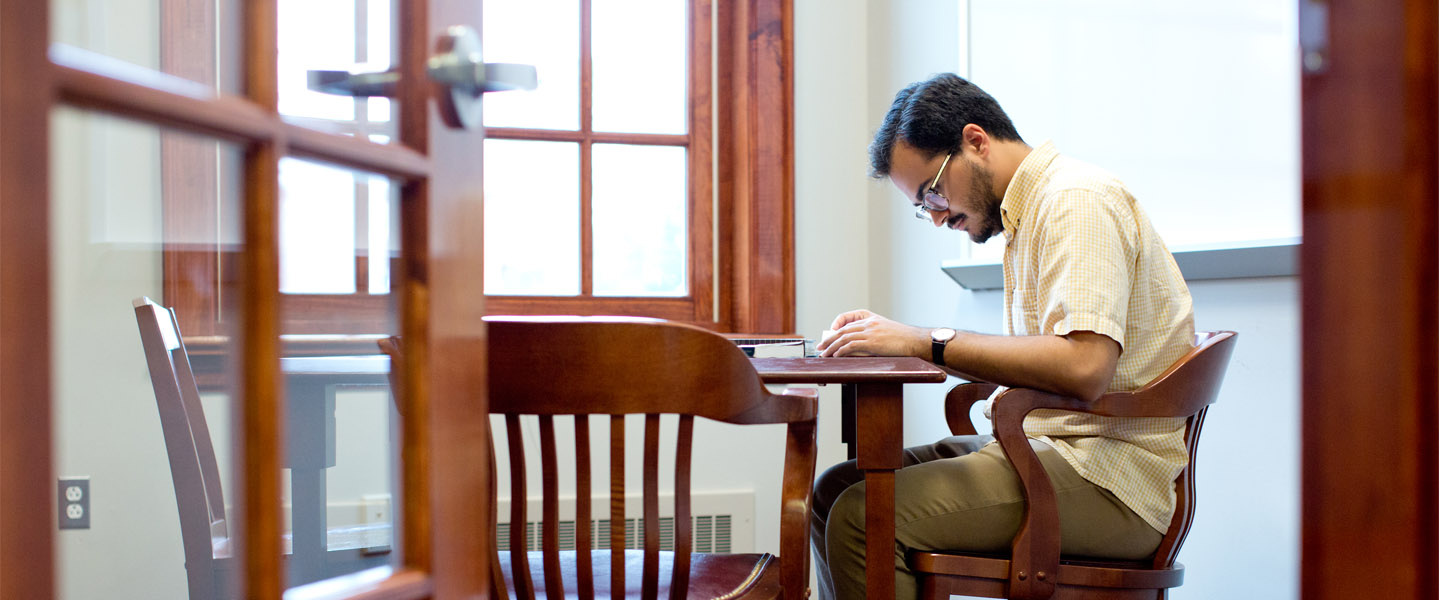 Chris Williams-Morales '17 studying in the library
