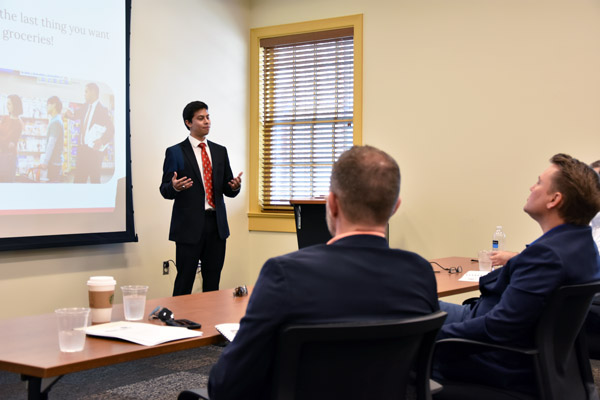 Luis presents to the panel of judges at the Tiger's Den Entrepreneurship Competition