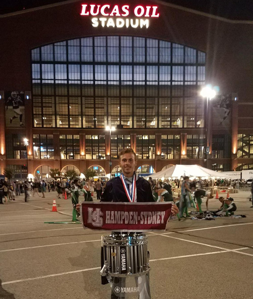 Sam Fleming '19 and Hampden-Sydney flag at the Carolina Crown DrumCorps Championship
