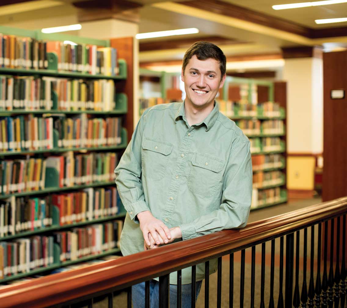 Will Fussy '18 standing in the Bortz Library stacks