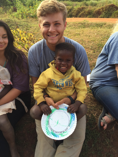 Hunter Williams '20 with a child in Uganda