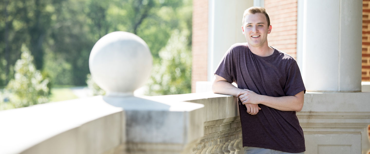 Max Dash stands on the terrace of the Bortz Library