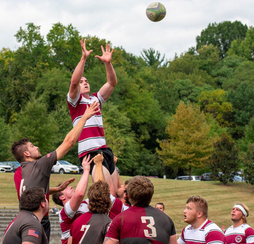 Rugby team helping a player to catch the ball, photo: Theresa Carriveau 
