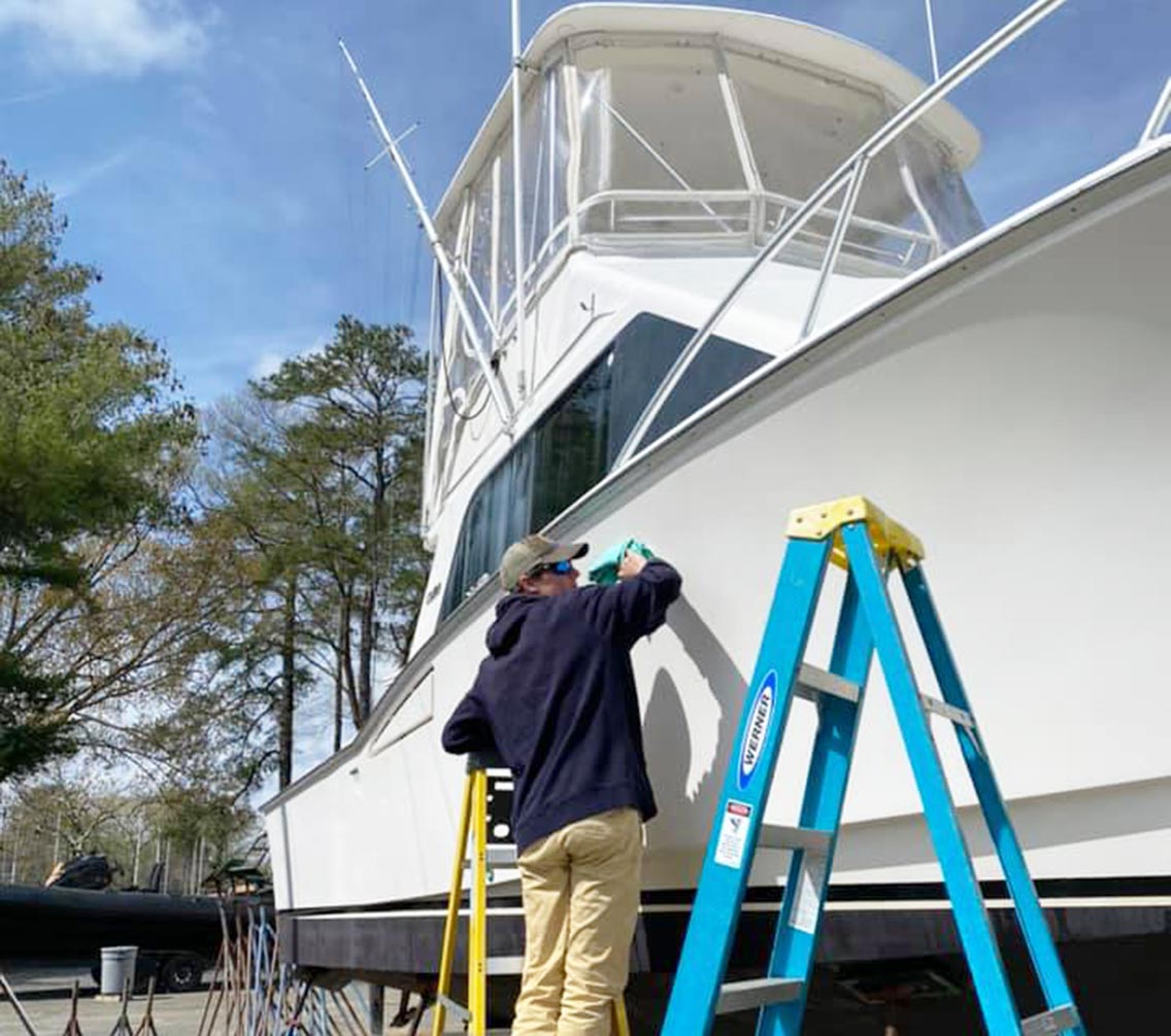 Ben Skinner cleaning and detailing a boat