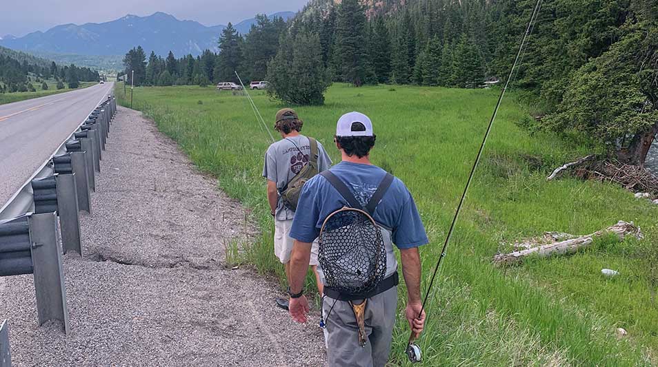 Zach Ayotte '20 and David King III '21 hiking a road in Bozeman, MT