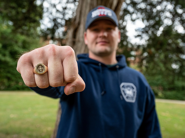 Peter Orgain '22 showing his class ring in a fist