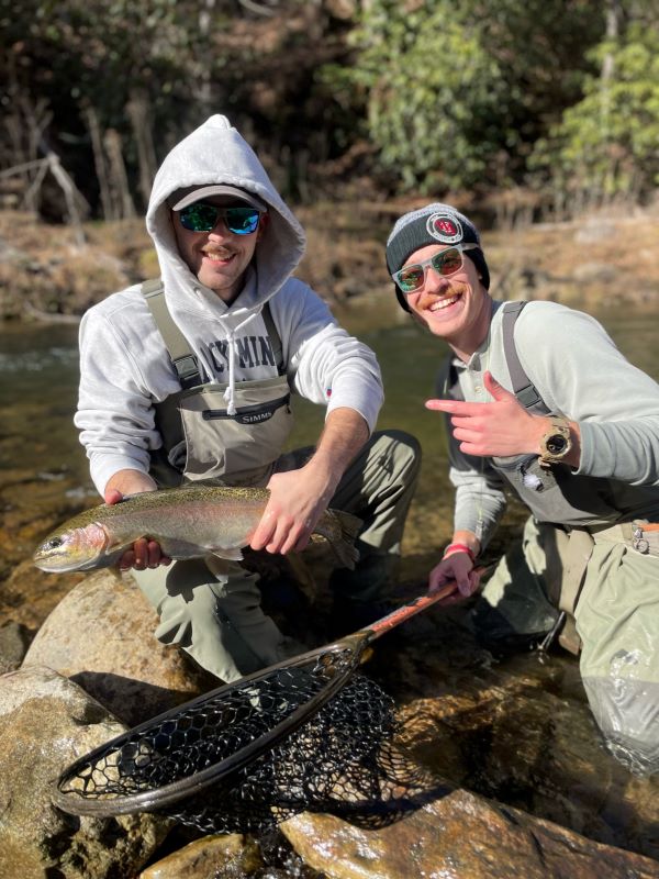 Grayson Phillips '23 displaying his catch on a fly-fishing trip