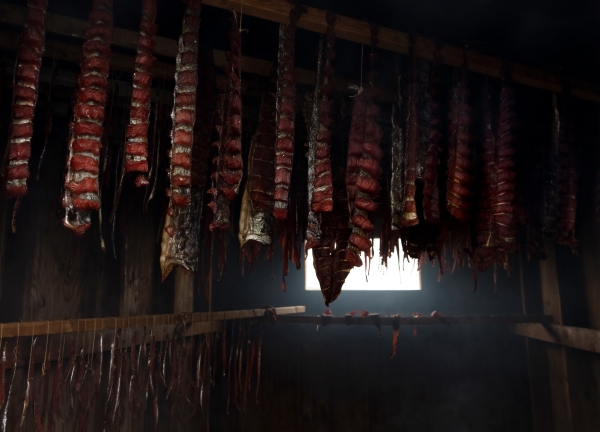 salmon drying in rows in a smokehouse in Alaska