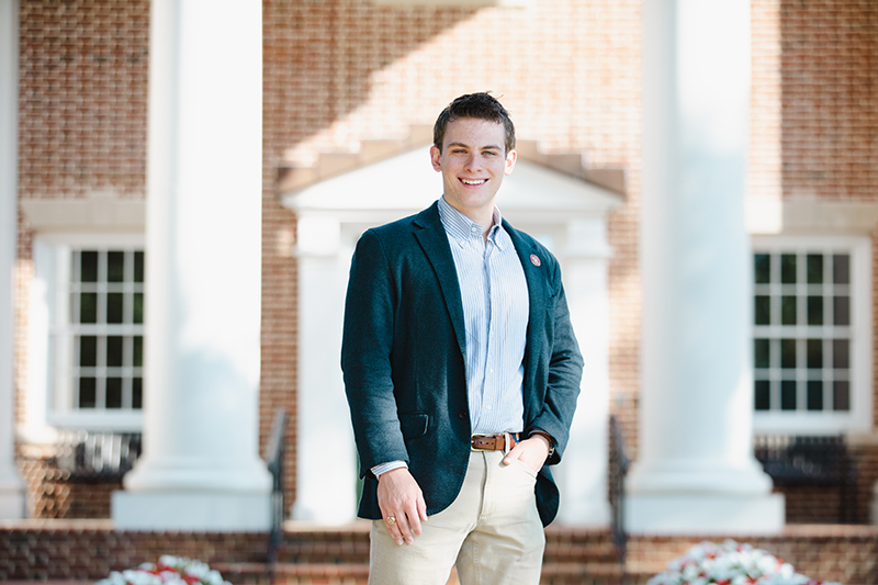 Noah Moore standing in front of a campus building