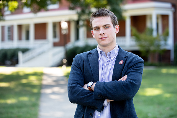 Noah Moore standing in front of a campus building