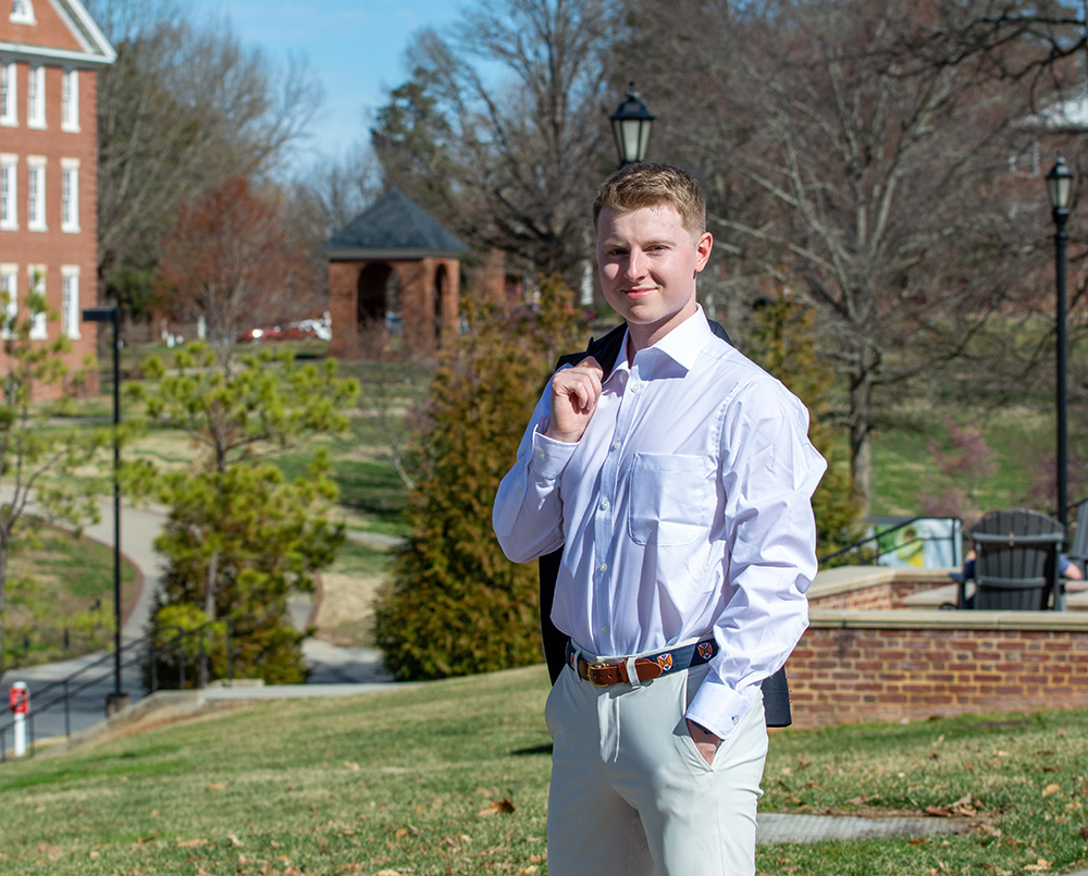 Noah Selfe '23 standing outside in front of H-SC Bell Tower