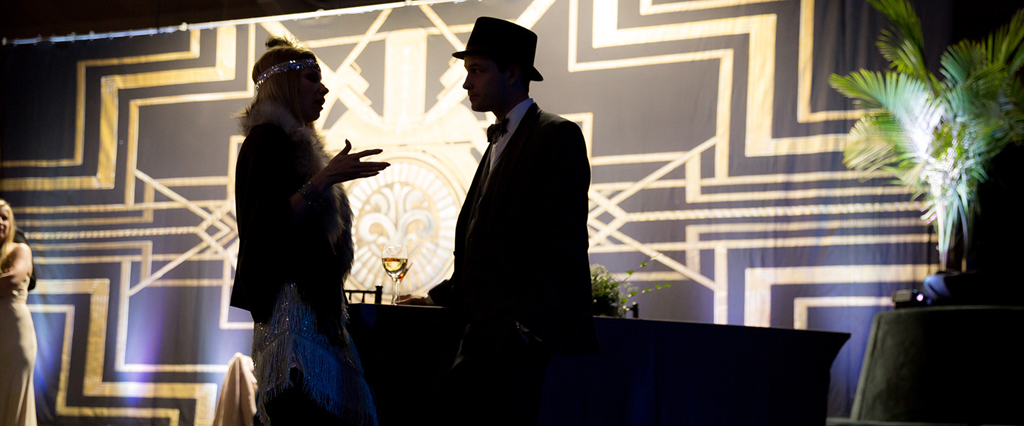 Students and their dates in formal attire dancing at a ball