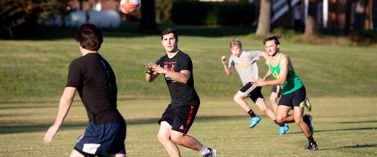 Friends playing a pick up rugby game at Hampden-Sydney College 