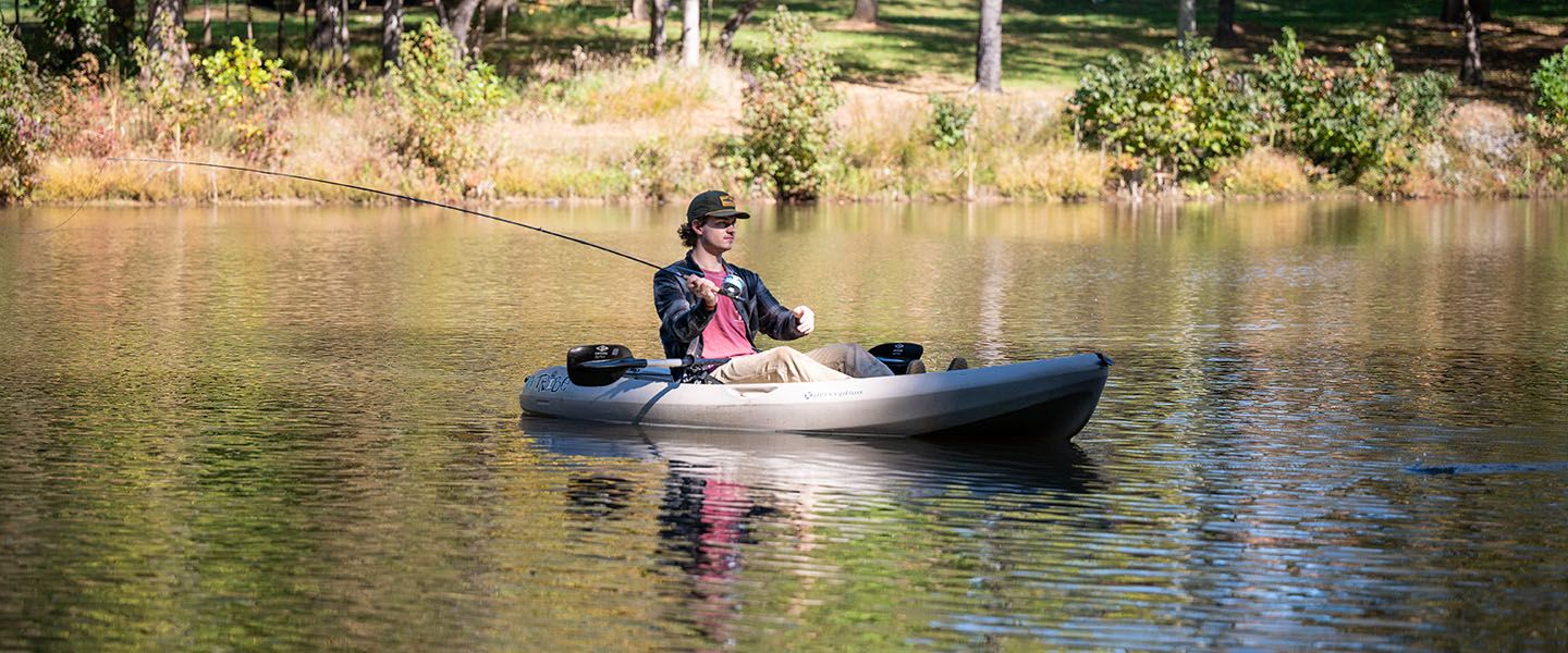 Student fishing in a kayak at the Hampden-Sydney College Chalgrove Pond