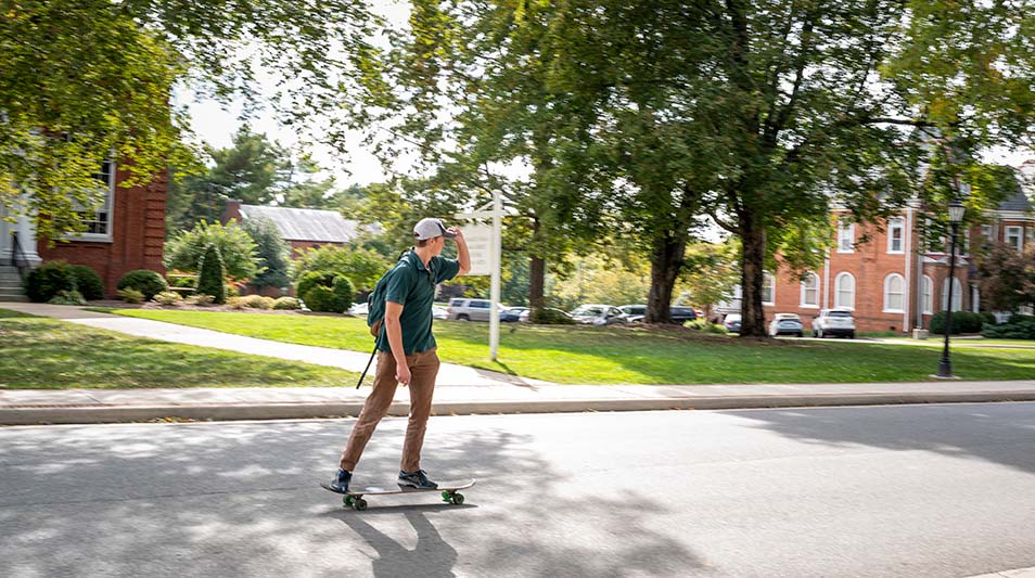 Student skateboarding campus at Hampden-Sydney College