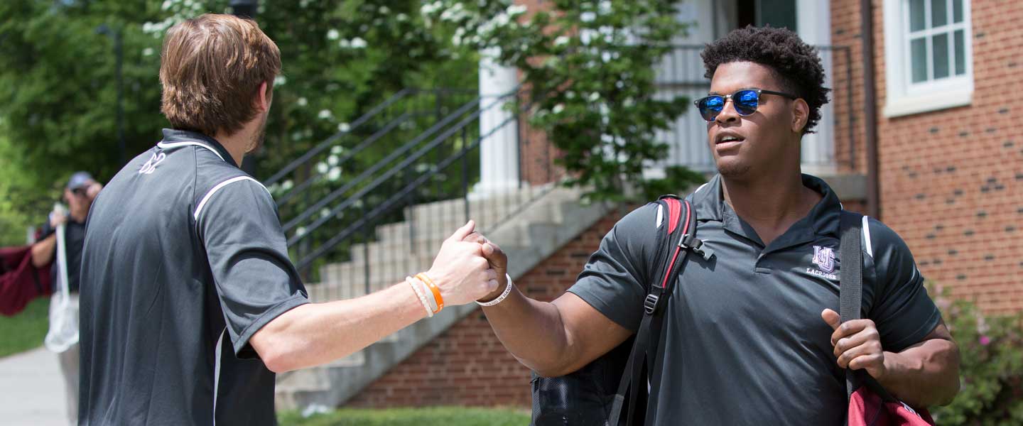 Two students fist bumping at Hampden-sydney College