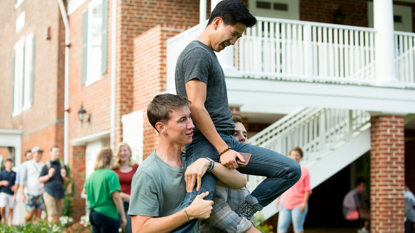 Students hoist the winner overhead at H-SC cornhole game