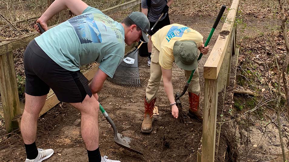 Hampden-Sydney College students working on a bridge on the Wilson Trail