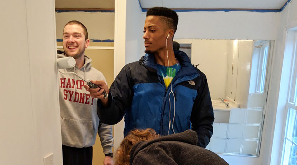 Hampden-Sydney College student volunteer, Henry O' Neal painting the interior of a Habitat for Humanity home